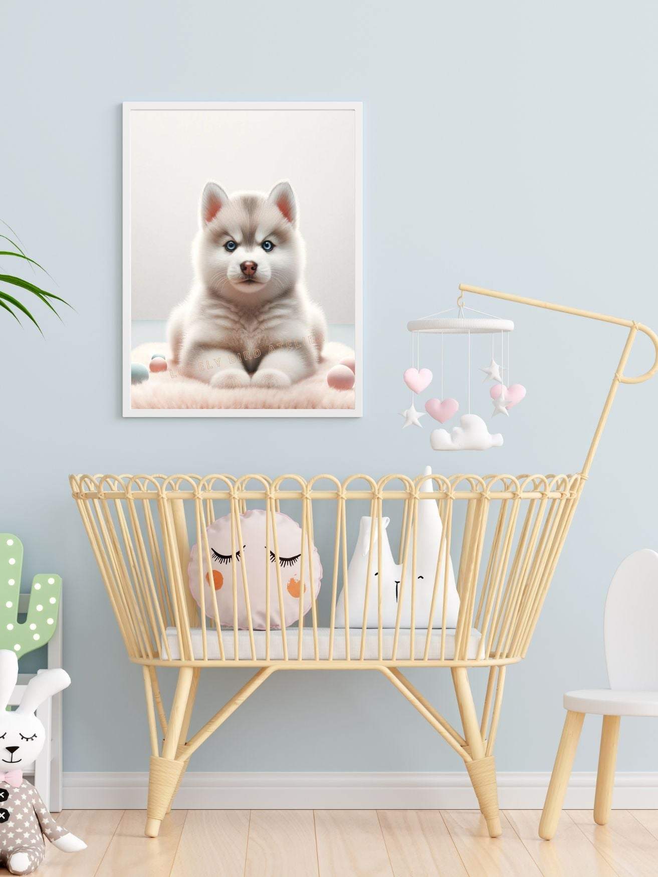 Chambre de bébé avec berceau en rotin, peluches et tableau d'un chiot Husky.