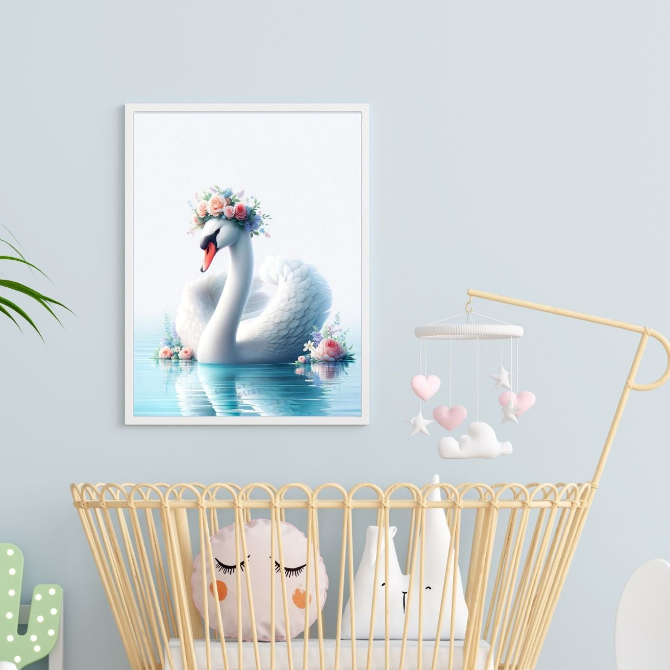 Berceau de bébé en rotin avec peluches et affiche de cygne couronné de fleurs dans une chambre de bébé.